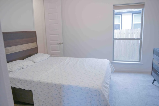 bedroom with carpet floors and baseboards