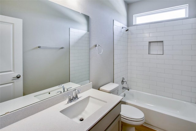 bathroom featuring bathing tub / shower combination, vanity, and toilet