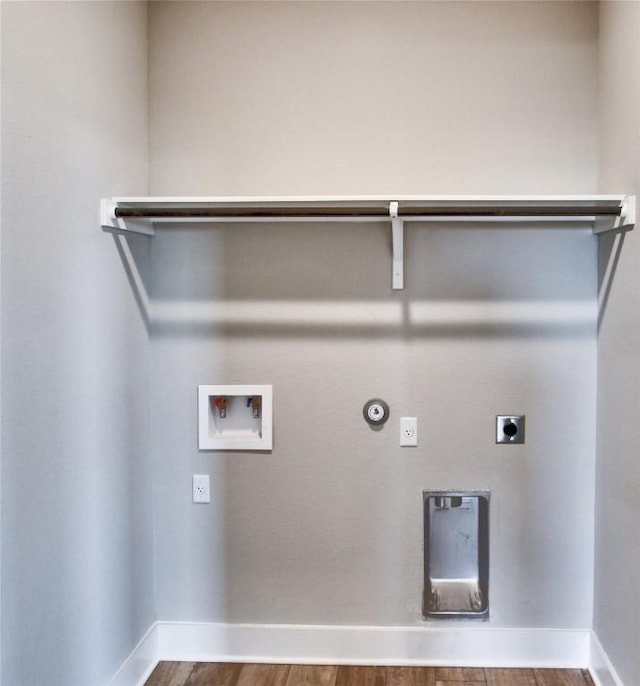 205 Pinnacle Ln, Kyle, TX 78640 - laundry room featuring hookup for an electric dryer, hookup for a gas dryer, wood finished floors, hookup for a washing machine, and baseboards