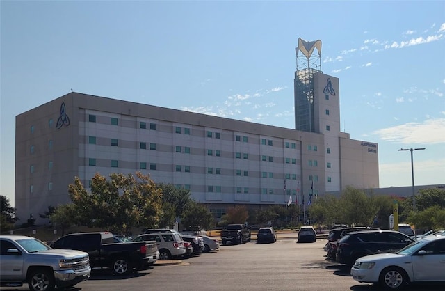 view of building exterior featuring uncovered parking