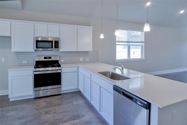 217 Pinnacle Ln, Kyle, TX 78640 - kitchen with appliances with stainless steel finishes, a sink, a peninsula, decorative backsplash, and dark wood-style floors