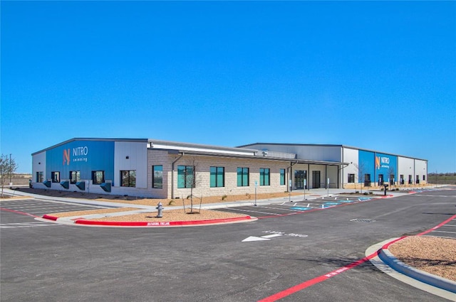 view of building exterior featuring uncovered parking