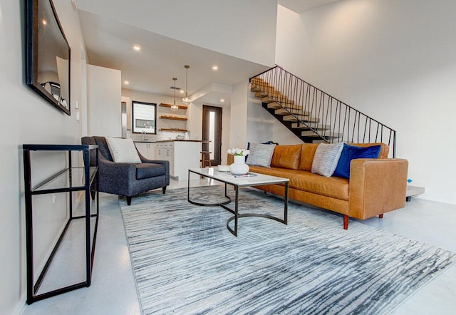 living room featuring stairway and recessed lighting