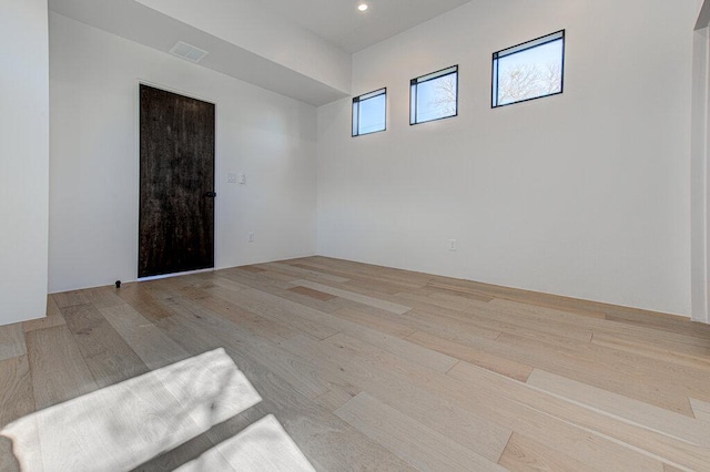 empty room with visible vents, wood finished floors, and recessed lighting