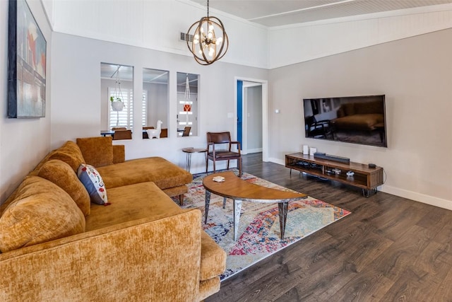 living room with visible vents, wood finished floors, crown molding, baseboards, and a chandelier