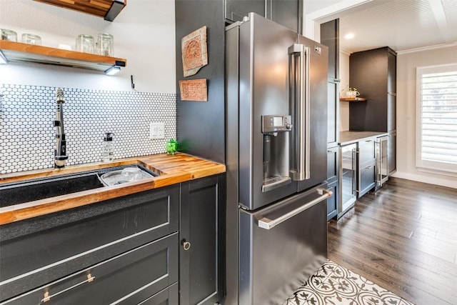 kitchen featuring dark wood-type flooring, open shelves, wood counters, backsplash, and high quality fridge