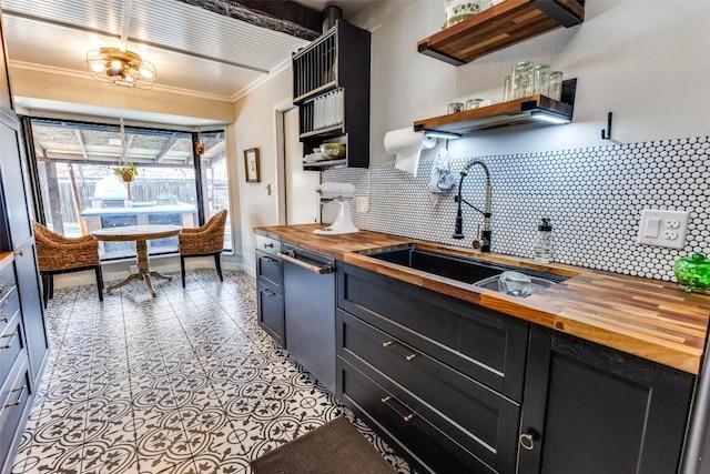 kitchen with wooden counters, open shelves, a sink, dishwasher, and crown molding