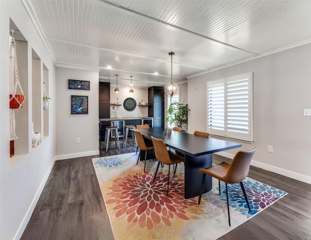 dining room with dark wood finished floors, baseboards, and ornamental molding