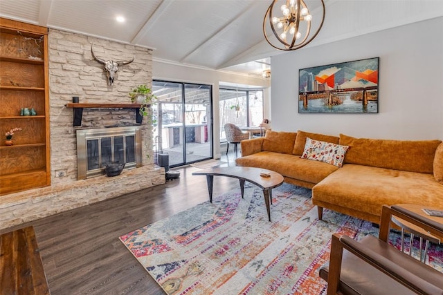 living area featuring a chandelier, a stone fireplace, lofted ceiling with beams, and wood finished floors