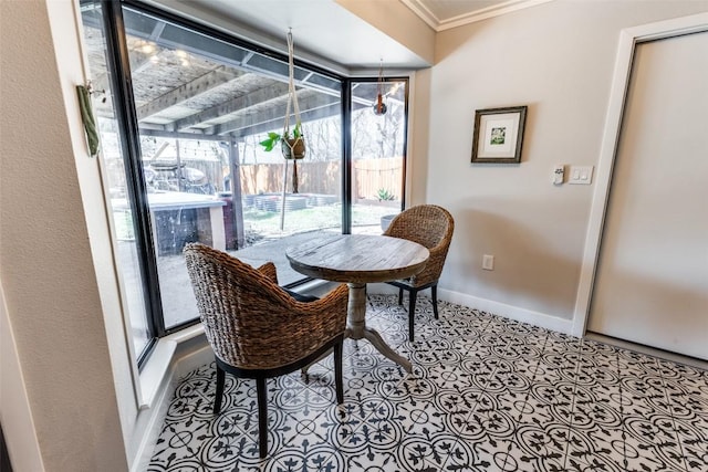 dining space with tile patterned flooring, baseboards, crown molding, and a sunroom