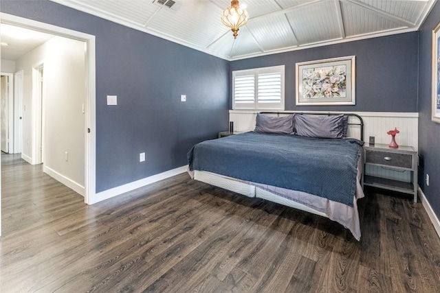 bedroom featuring visible vents, baseboards, and wood finished floors