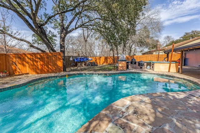 view of pool with area for grilling, a fenced in pool, a patio, and a fenced backyard