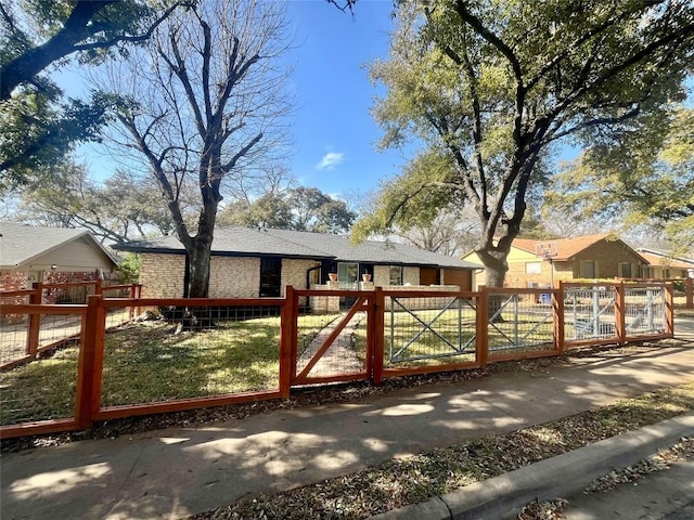 view of gate featuring a fenced front yard