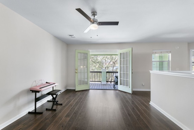 interior space featuring baseboards, wood finished floors, visible vents, and a healthy amount of sunlight