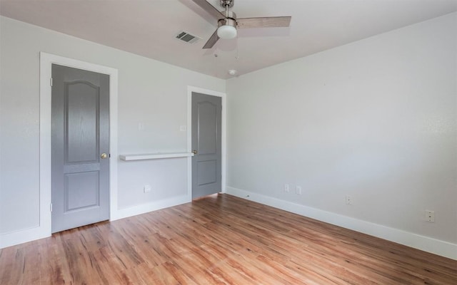 unfurnished bedroom featuring light wood-type flooring, baseboards, visible vents, and ceiling fan