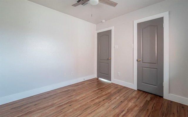 interior space featuring ceiling fan, light wood-type flooring, and baseboards