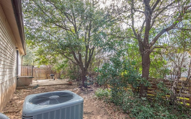 view of yard featuring fence and cooling unit