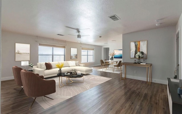 living area with a textured ceiling, visible vents, and wood finished floors