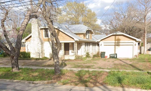 view of front facade with stone siding, covered porch, and an attached garage