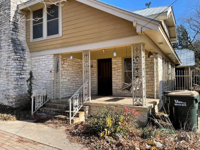 view of front of property with covered porch and metal roof