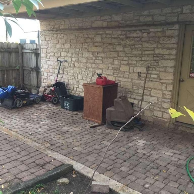 view of patio featuring fence