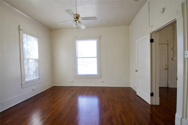 unfurnished room featuring ceiling fan, baseboards, and wood finished floors