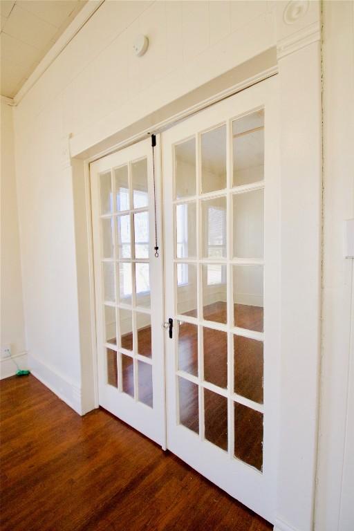 doorway to outside with dark wood-style floors, french doors, and baseboards