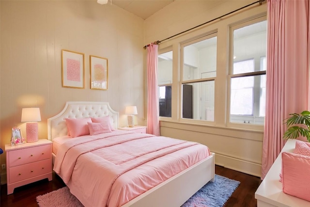 bedroom with dark wood-style floors