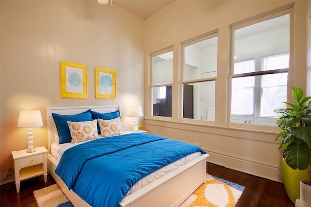 bedroom featuring baseboards and wood finished floors