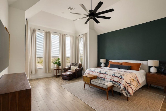 bedroom featuring baseboards, visible vents, a ceiling fan, wood finished floors, and vaulted ceiling