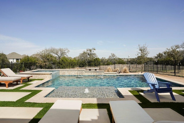 view of swimming pool featuring a patio, fence, and a pool with connected hot tub