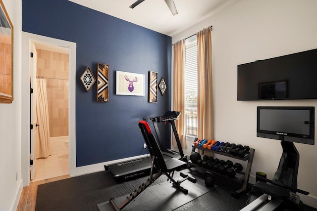 exercise area with baseboards and a ceiling fan