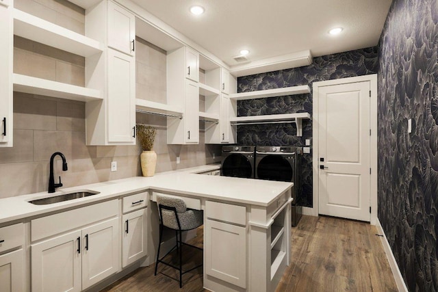 kitchen featuring white cabinets, a sink, separate washer and dryer, and open shelves