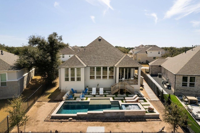 rear view of property featuring a patio area, a fenced backyard, a fenced in pool, and roof with shingles