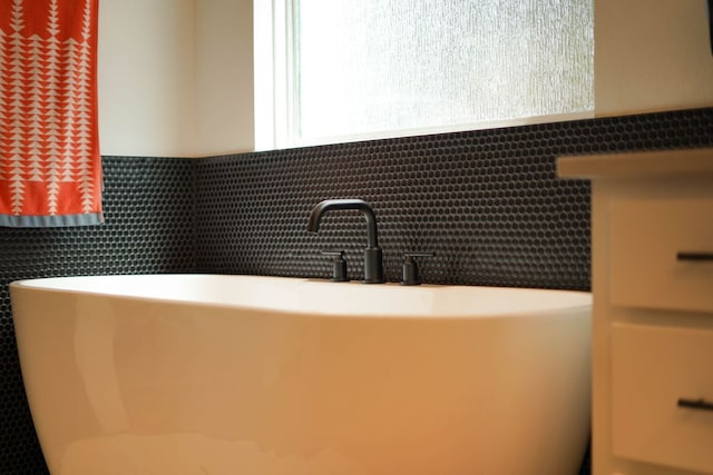 interior space featuring a sink and a freestanding bath