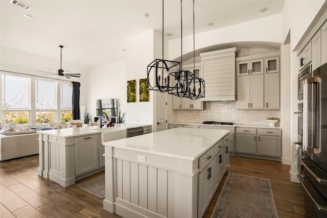 296 Running Bird Rd, Austin, TX 78737 - kitchen with a kitchen island, appliances with stainless steel finishes, gray cabinets, a ceiling fan, and recessed lighting