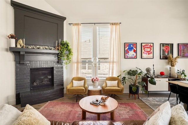 296 Running Bird Rd, Austin, TX 78737 - living area featuring vaulted ceiling, a brick fireplace, and wood finished floors