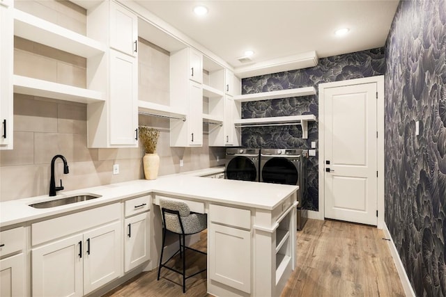 296 Running Bird Rd, Austin, TX 78737 - kitchen featuring open shelves, independent washer and dryer, white cabinetry, light countertops, and wallpapered walls