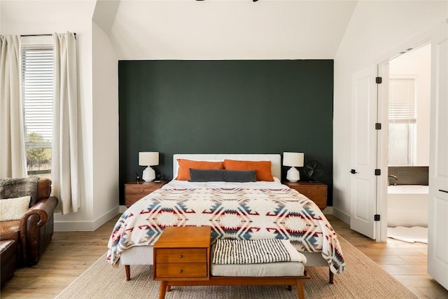 296 Running Bird Rd, Austin, TX 78737 - bedroom with light wood-type flooring, vaulted ceiling, and baseboards