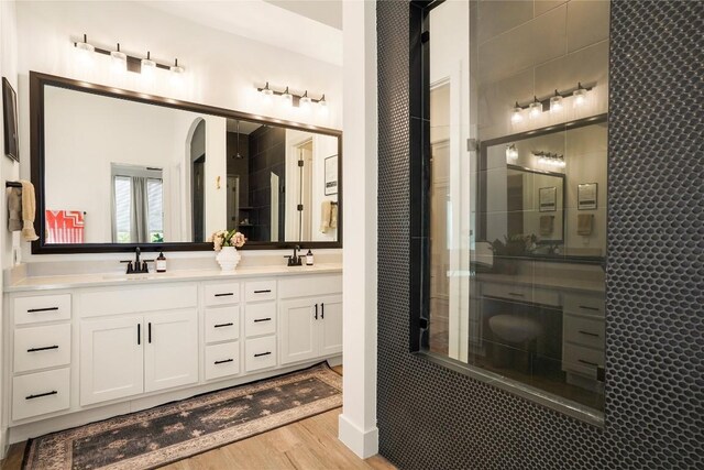296 Running Bird Rd, Austin, TX 78737 - bathroom with double vanity, wood finished floors, and a sink