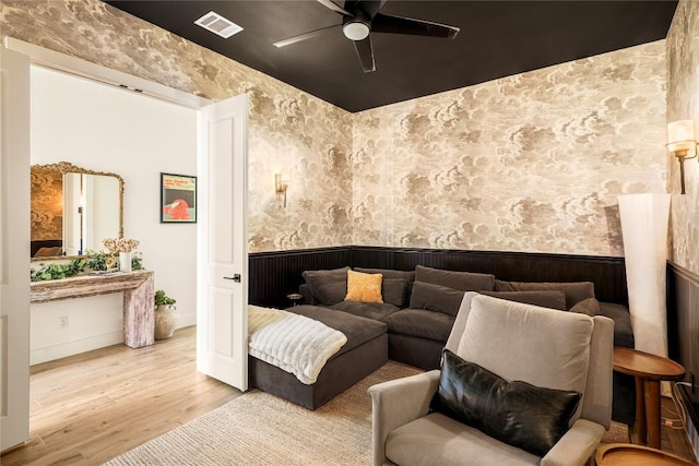296 Running Bird Rd, Austin, TX 78737 - interior space with ceiling fan, a wainscoted wall, wood finished floors, and wallpapered walls