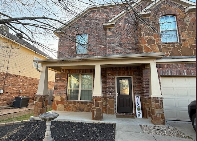 view of front of property with covered porch, stone siding, brick siding, and central air condition unit