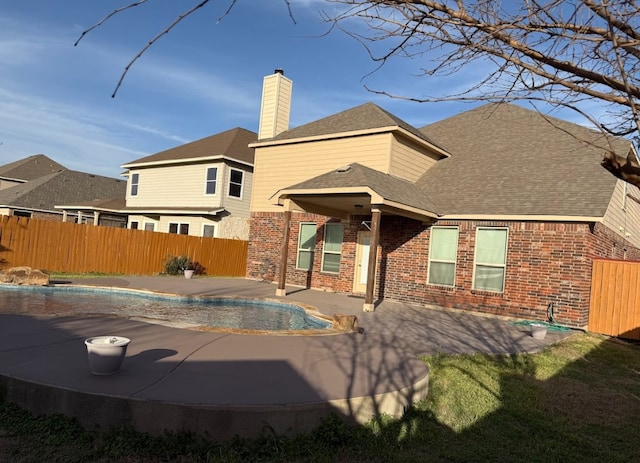 back of house with a patio area, brick siding, and fence