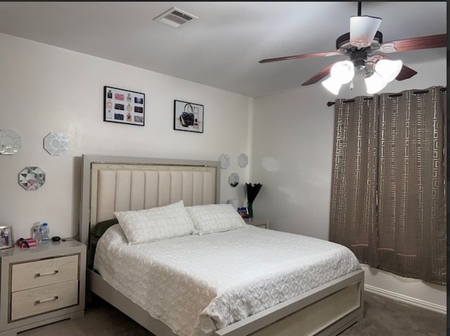 carpeted bedroom featuring visible vents and a ceiling fan