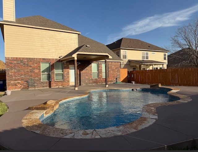 view of swimming pool with a patio, fence, and a fenced in pool