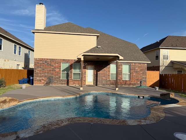 view of swimming pool with a patio, fence, and a fenced in pool