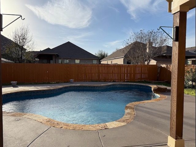 view of swimming pool with a fenced backyard, a fenced in pool, and a patio