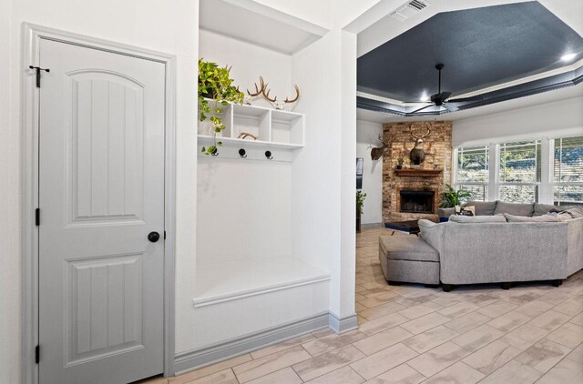 2807 Grimes Crossing Rd, Copperas Cove, TX 76522 - mudroom featuring a ceiling fan, a raised ceiling, a stone fireplace, and baseboards
