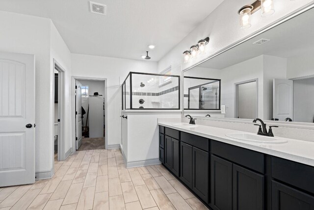 2807 Grimes Crossing Rd, Copperas Cove, TX 76522 - full bath featuring a stall shower, double vanity, wood finished floors, and baseboards