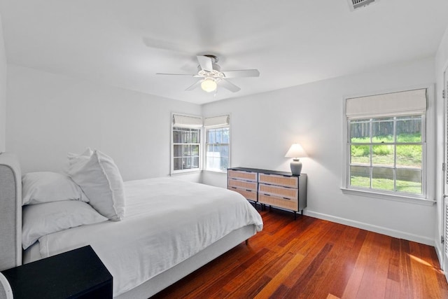 bedroom with hardwood / wood-style flooring, baseboards, and a ceiling fan